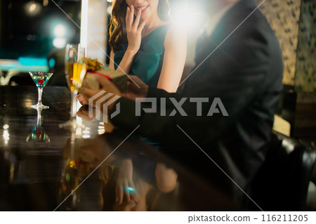 Men and women drinking at a bar Men and women drinking at a bar 116211205