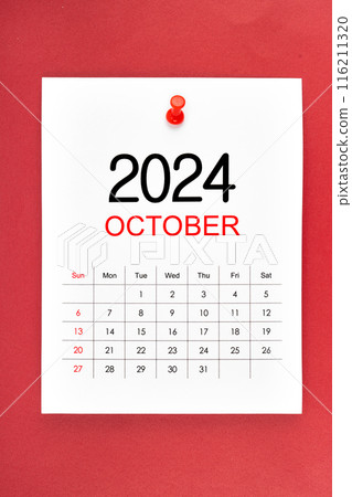 October 2024 calendar page with push pin on red background. October 2024 calendar page with push pin on red background. 116211320