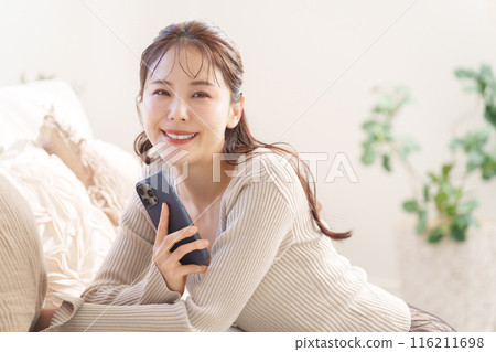 A woman using a smartphone 116211698