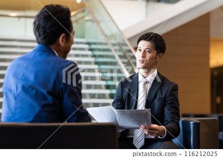 Businessmen discussing Businessmen discussing 116212025