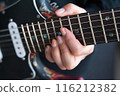 A woman playing the guitar 116212382