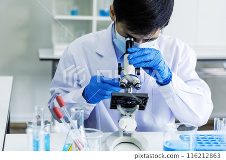 Scientist man look into Microscope research in science laboratory. Asian scientist look at microbiology microscope laboratory equipment chemistry lab. Biochemistry research experiment vaccine concept Scientist man look into Microscope research in science laboratory. Asian scientist look at microbiology microscope laboratory equipment chemistry lab. Biochemistry research experiment vaccine concept 116212863