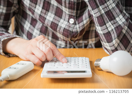Person calculating electricity bill 116213705
