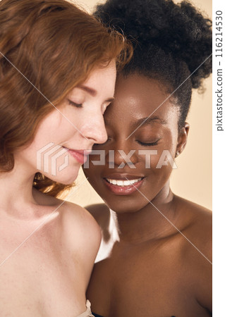 Two Diverse Women with Eyes Closed and Smiling 116214530