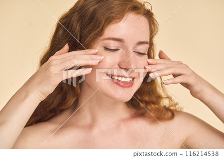 Woman Applying Skincare Cream on Face Woman Applying Skincare Cream on Face 116214538