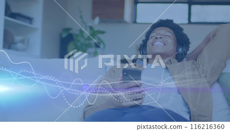 Image of music data processing over african american man with headphones 116216360
