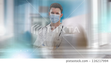 Image of caucasian healthcare professional wearing mask and stethoscope, standing confidently Image of caucasian healthcare professional wearing mask and stethoscope, standing confidently 116217994