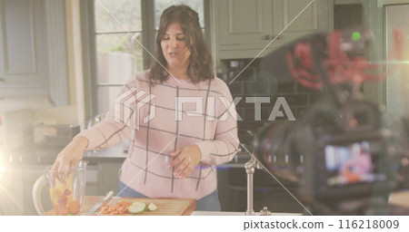 Image of glowing light over camera with female vlogger recording culinary vlog at home Image of glowing light over camera with female vlogger recording culinary vlog at home 116218009