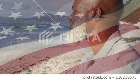 Image of flag of united states of america over senior african american man on beach Image of flag of united states of america over senior african american man on beach 116218573