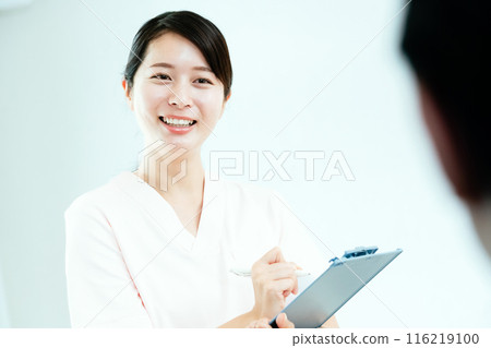 Female nurse talking to patient 116219100