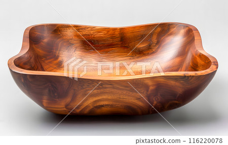 A square wooden bowl, crafted from a rich, warm-toned wood, sits on a gray background. A square wooden bowl, crafted from a rich, warm-toned wood, sits on a gray background. 116220078