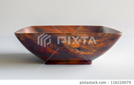 A square wooden bowl, crafted from a rich, warm-toned wood, sits on a gray background. A square wooden bowl, crafted from a rich, warm-toned wood, sits on a gray background. 116220079