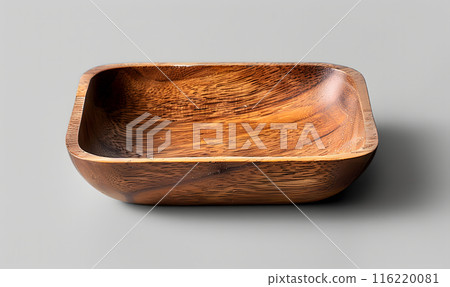 A square wooden bowl, crafted from a rich, warm-toned wood, sits on a gray background. A square wooden bowl, crafted from a rich, warm-toned wood, sits on a gray background. 116220081