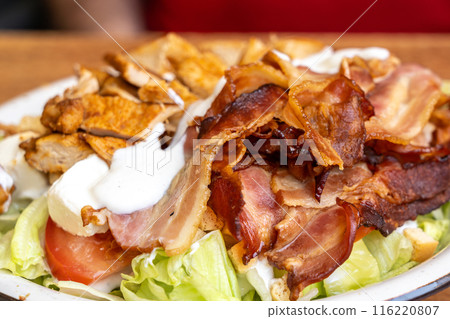 Polish Caesar salad with chicken, bacon and vegetables, high-calorie meat salad with fresh vegetables 116220807