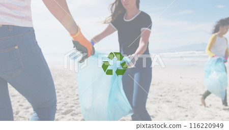 Image of recycling icon over volunteers cleaning beach 116220949