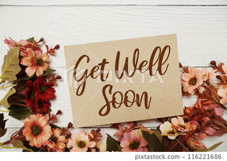 Get well Soon typography text with flower decorated on wooden background 116221686