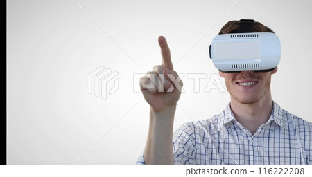 Image of caucasian man wearing vr headset gesturing against grey background with copy space 116222208