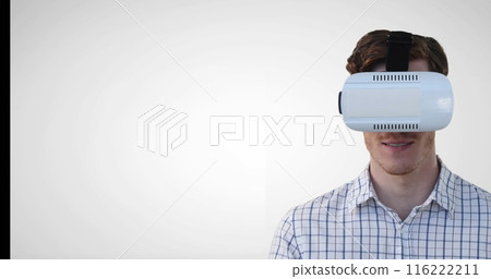 Image of caucasian man wearing vr headset gesturing against grey background with copy space Image of caucasian man wearing vr headset gesturing against grey background with copy space 116222211