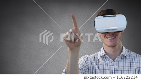Image of caucasian man wearing vr headset gesturing against grey background with copy space 116222214