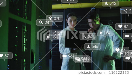 Image of social media icons and numbers over diverse it technicians by computer server 116222353