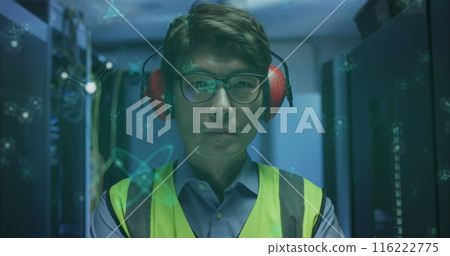 Image of molecular structures floating over asian male engineer standing at server room Image of molecular structures floating over asian male engineer standing at server room 116222775