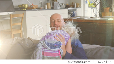 Image of light spots over happy caucasian father holding daughter at home 116223182
