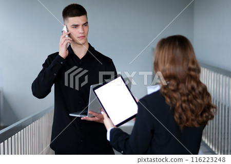 Guy and girl in the office hand woman sitting use tablet computer with horizontal white screen typing display internet touchpad connection touchscreen communication chroma finger message mobile Guy and girl in the office hand woman sitting use tablet computer with horizontal white screen typing display internet touchpad connection touchscreen communication chroma finger message mobile 116223248
