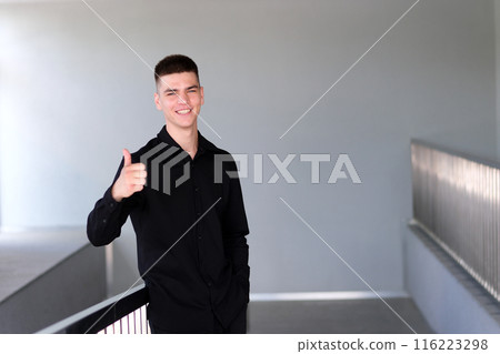 Thumbs up man. Handsome man with black hair and blue eyes. Mixed race nationality smiling happy satisfied young man 20s showing thumbs up like gesture. Thumbs up man. Handsome man with black hair and blue eyes. Mixed race nationality smiling happy satisfied young man 20s showing thumbs up like gesture. 116223298