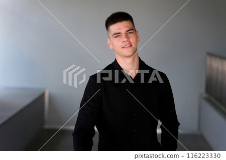 Close up of man face. Serious looking on the camera. Slow motion Handsome man with black hair and blue eyes. Mixed race nationality 116223330