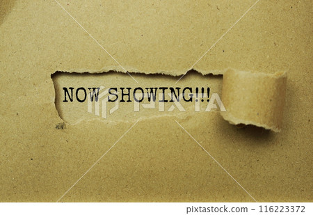 Now Showing message written on craft paper with torn paper background 116223372