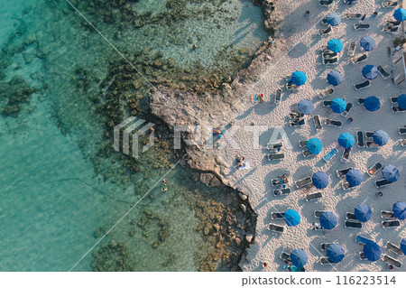 Aerial view of Nissi beach resort with blue umbrellas. Ayia Napa, Cyprus Aerial view of Nissi beach resort with blue umbrellas. Ayia Napa, Cyprus 116223514