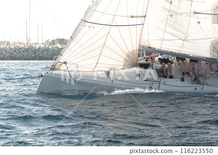 Yacht racing in the serene mediterranean sea during a regatta event Yacht racing in the serene mediterranean sea during a regatta event 116223550