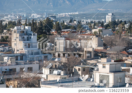 Overlooking the dense Nicosia cityscape with buildings and mountains in the background 116223559