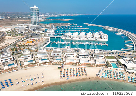 Aerial view of a modern Ayia Napa marina with tourists relaxing on the beach. Cyprus 116223568