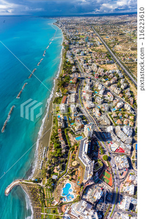Aerial view of a coastal city with hotels and resorts lining the beachfront. Limassol, Cyprus 116223610
