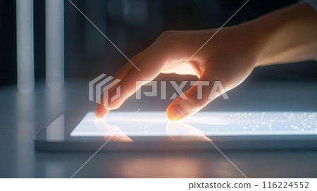 Hand Interacting with Bright Tablet Screen 116224552