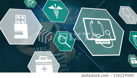 Image of medical icons falling over woman using vr headset 116224560