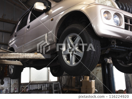 Car being repaired at a repair shop 116224920