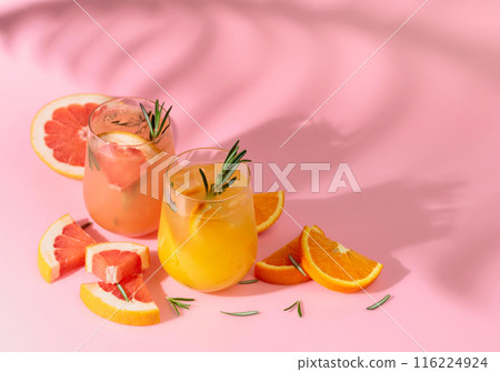Summer cocktails with grapefruit, orange, rosemary, and ice. 116224924
