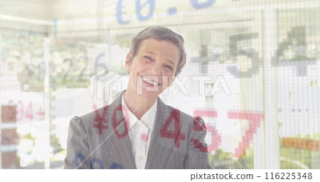 Image of trading board over caucasian woman smiling and standing arms crossed in office 116225348