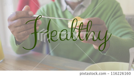 Image of healthy text over african american man eating breakfast Image of healthy text over african american man eating breakfast 116226160