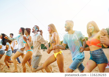 Teenagers Friends have fun at the holi festival. Beach Party. Celebrating traditional indian spring holiday. 116226283