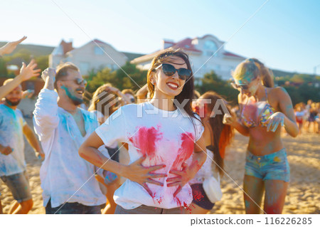 A group of friends have fun, dance at the holi festival. Celebrating traditional indian spring holiday. Friendship. 116226285