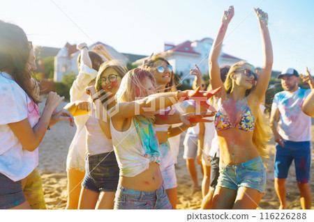 Teenagers Friends have fun at the holi festival. Beach Party. Celebrating traditional indian spring holiday. Teenagers Friends have fun at the holi festival. Beach Party. Celebrating traditional indian spring holiday. 116226288