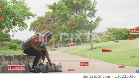 Image of notification icons over african american male athlete with prosthetic leg in park Image of notification icons over african american male athlete with prosthetic leg in park 116226386