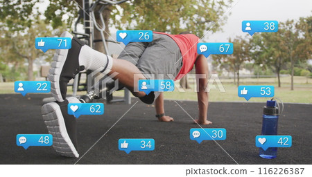 Image of social media icons with numbers, african american man with prosthetic leg doing plank 116226387