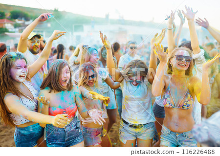 A group of friends have fun, dance at the holi festival. Celebrating traditional indian spring holiday. Friendship. A group of friends have fun, dance at the holi festival. Celebrating traditional indian spring holiday. Friendship. 116226488