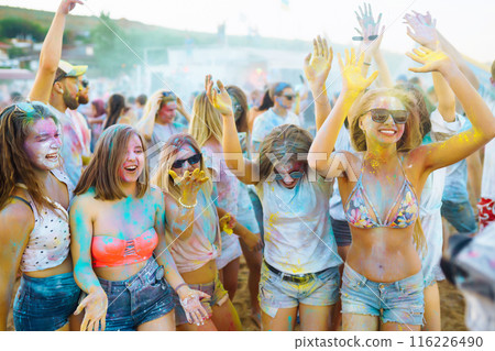 Teenagers Friends have fun at the holi festival. Beach Party. Celebrating traditional indian spring holiday. 116226490