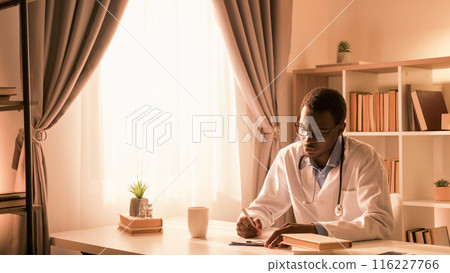 Doctor occupation. Medical paperwork. Healthcare practice. Male physician working writing record at modern workplace interior with copy space. 116227766