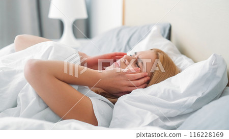 Fatigue migraine. Hopeless stressed. Life despair. Tired worried girl touching face feeling pain thinking about trouble alone in bed. Fatigue migraine. Hopeless stressed. Life despair. Tired worried girl touching face feeling pain thinking about trouble alone in bed. 116228169